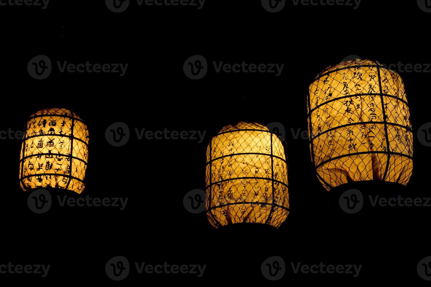 japonês lanterna brilhando dentro a Preto fundo foto