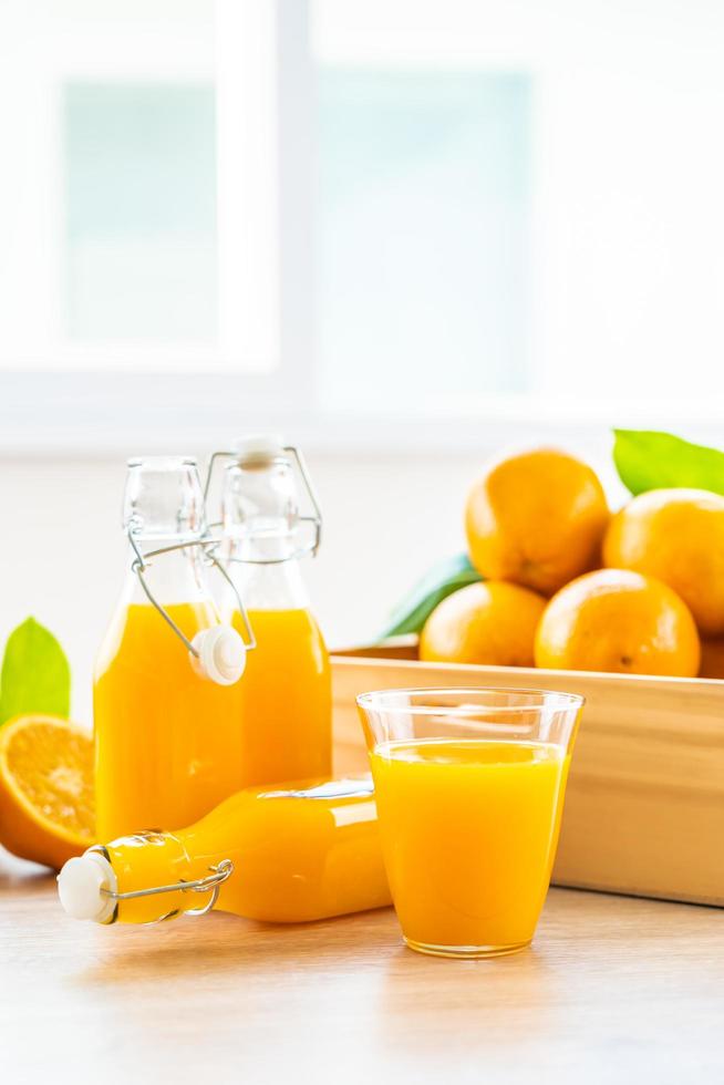 suco de laranja fresco e laranjas foto