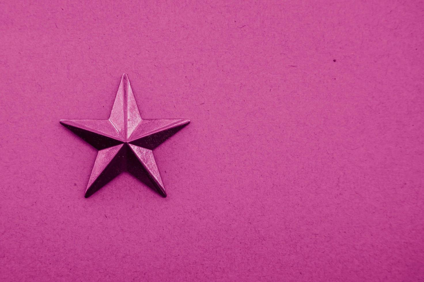 uma estrela rosa no fundo rosa foto