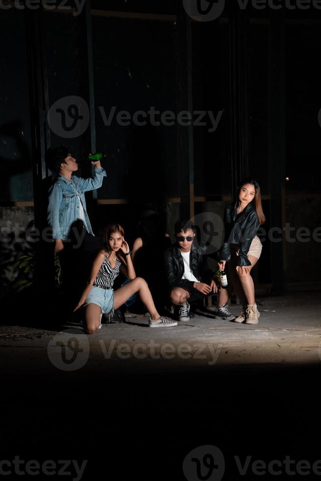 uma grupo do adolescentes dentro peculiar roupas estão desfrutando uma festa juntos às a fim do a ano dentro a velho construção foto