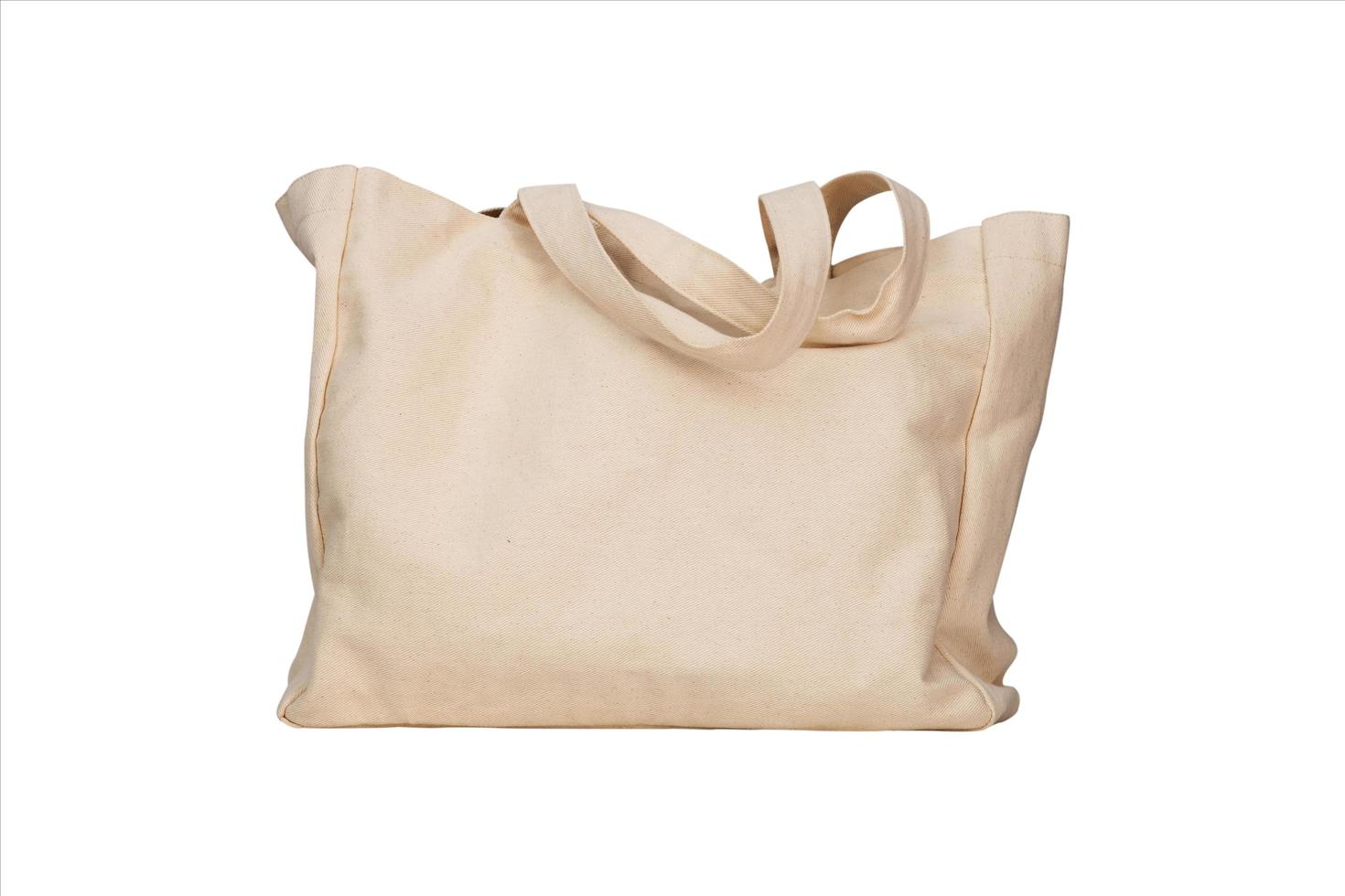 bolsa de lona de tecido isolada em um fundo branco, maquete ecológica reutilizável de tecido de uma sacola de compras e um modelo em branco para o design foto