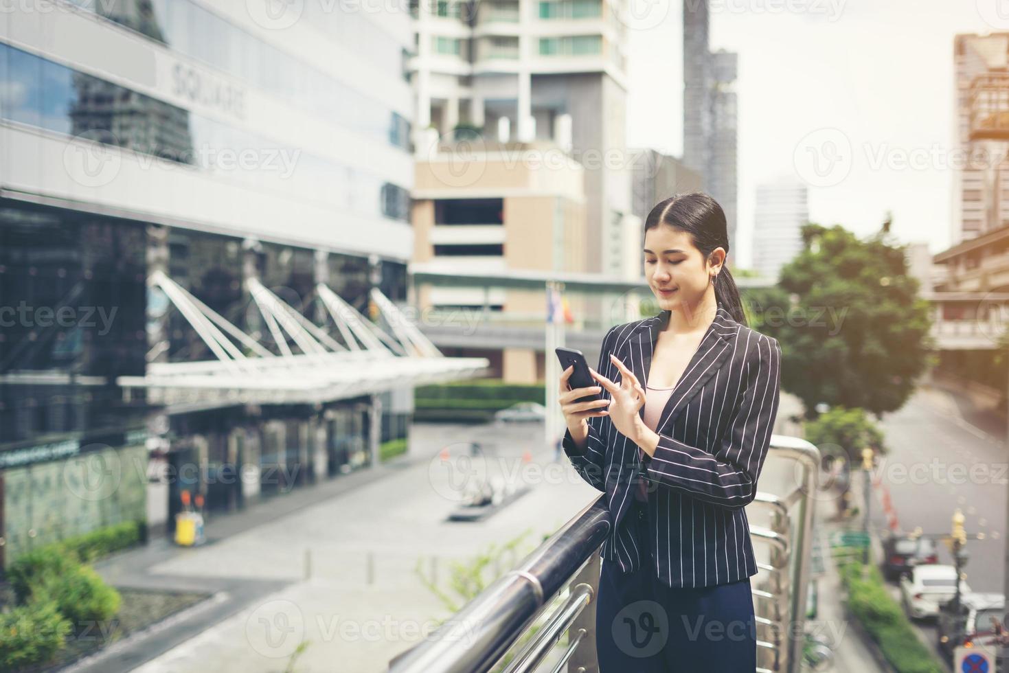 jovem empresária asiática usando smartphone móvel foto