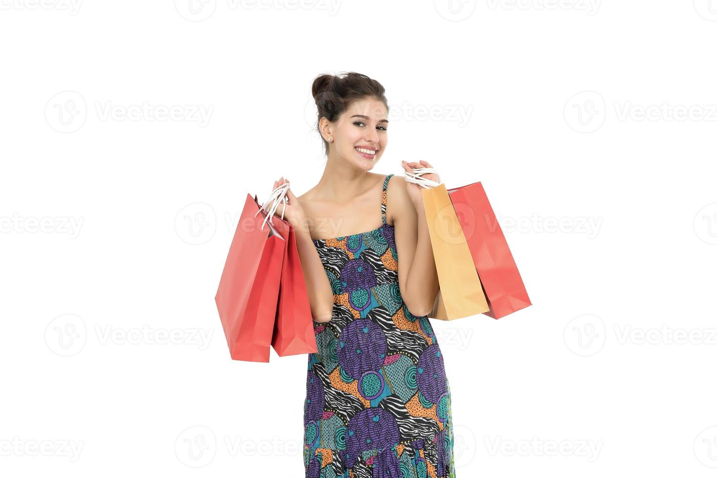 bela jovem segurando sacolas de compras sobre fundo branco foto