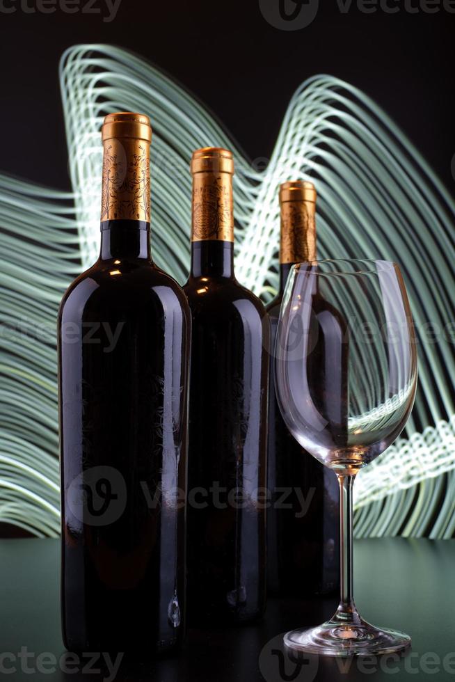 garrafas de vinho e copo com fundo de linhas brancas foto