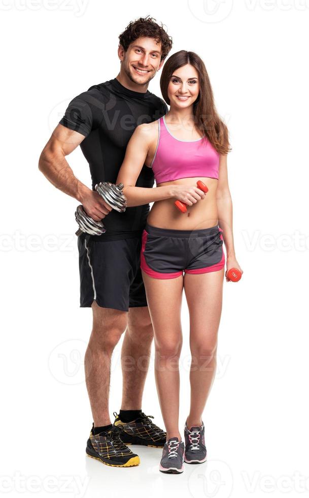 Atlético casal - homem e mulher com halteres em a branco foto