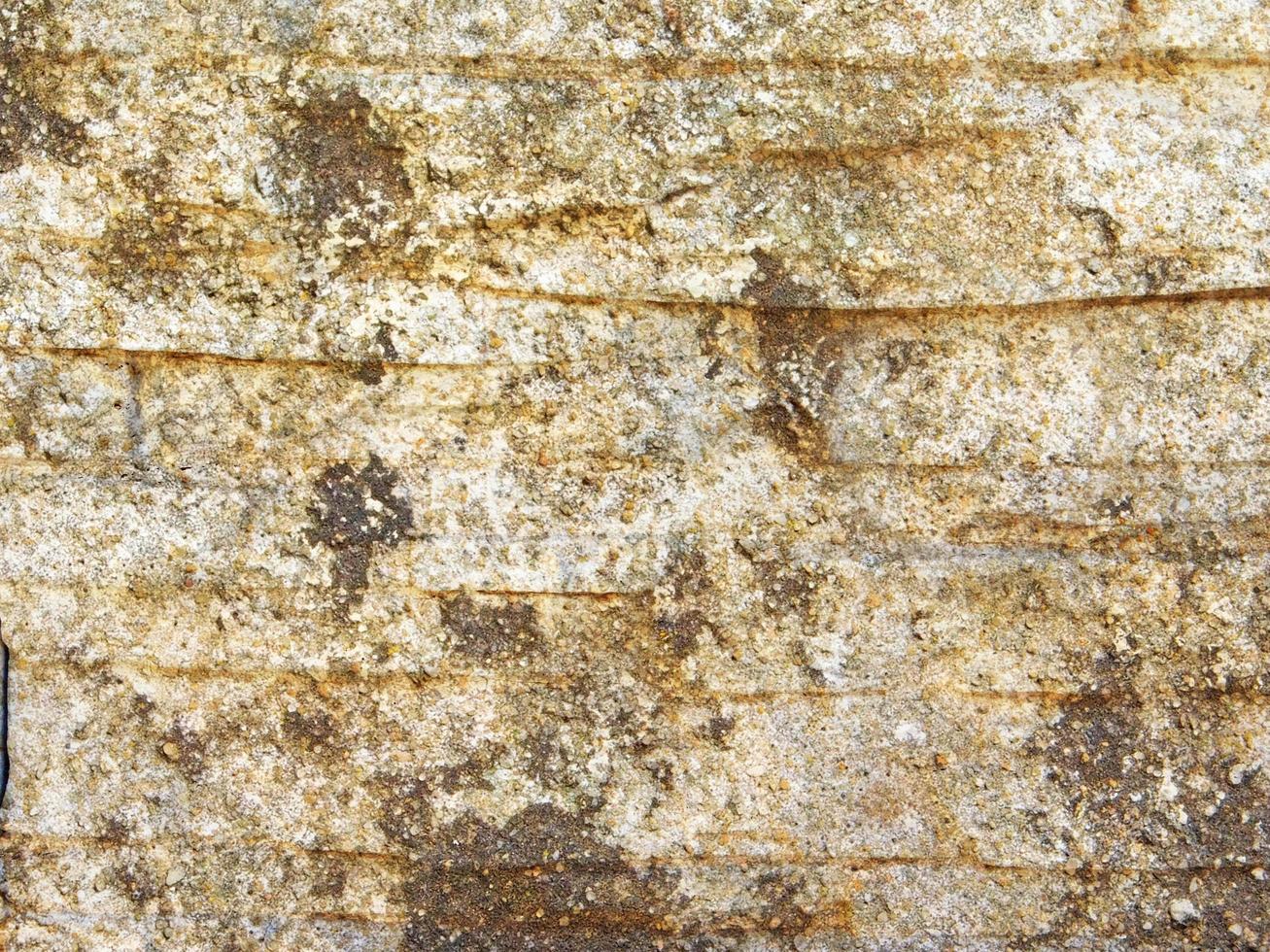rocha ou parede de pedra para plano de fundo ou textura foto