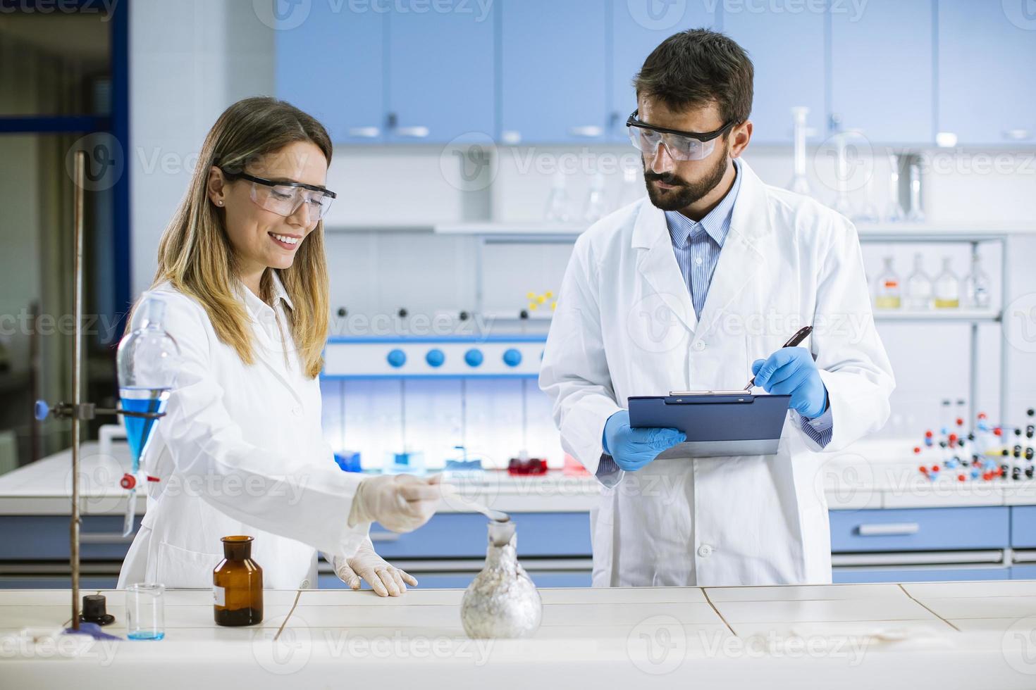 pesquisadores fazendo experimentos com fumaça em uma mesa de um laboratório químico foto