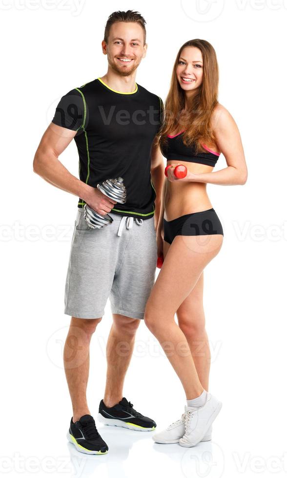 Atlético homem e mulher com halteres em a branco foto