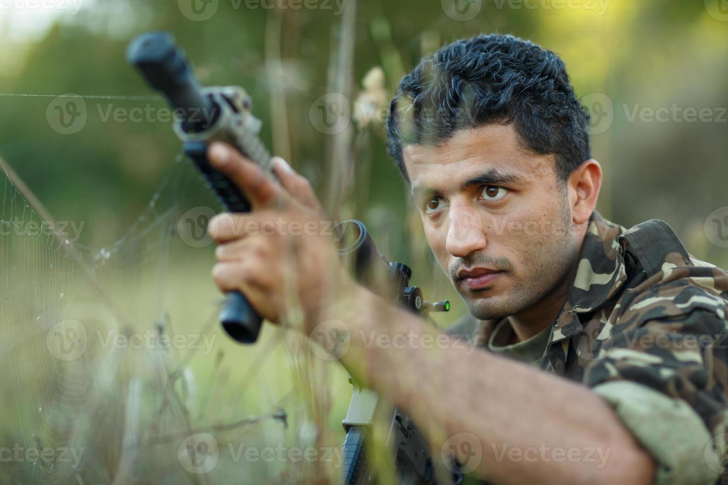 jovem masculino soldado com máquina arma de fogo foto