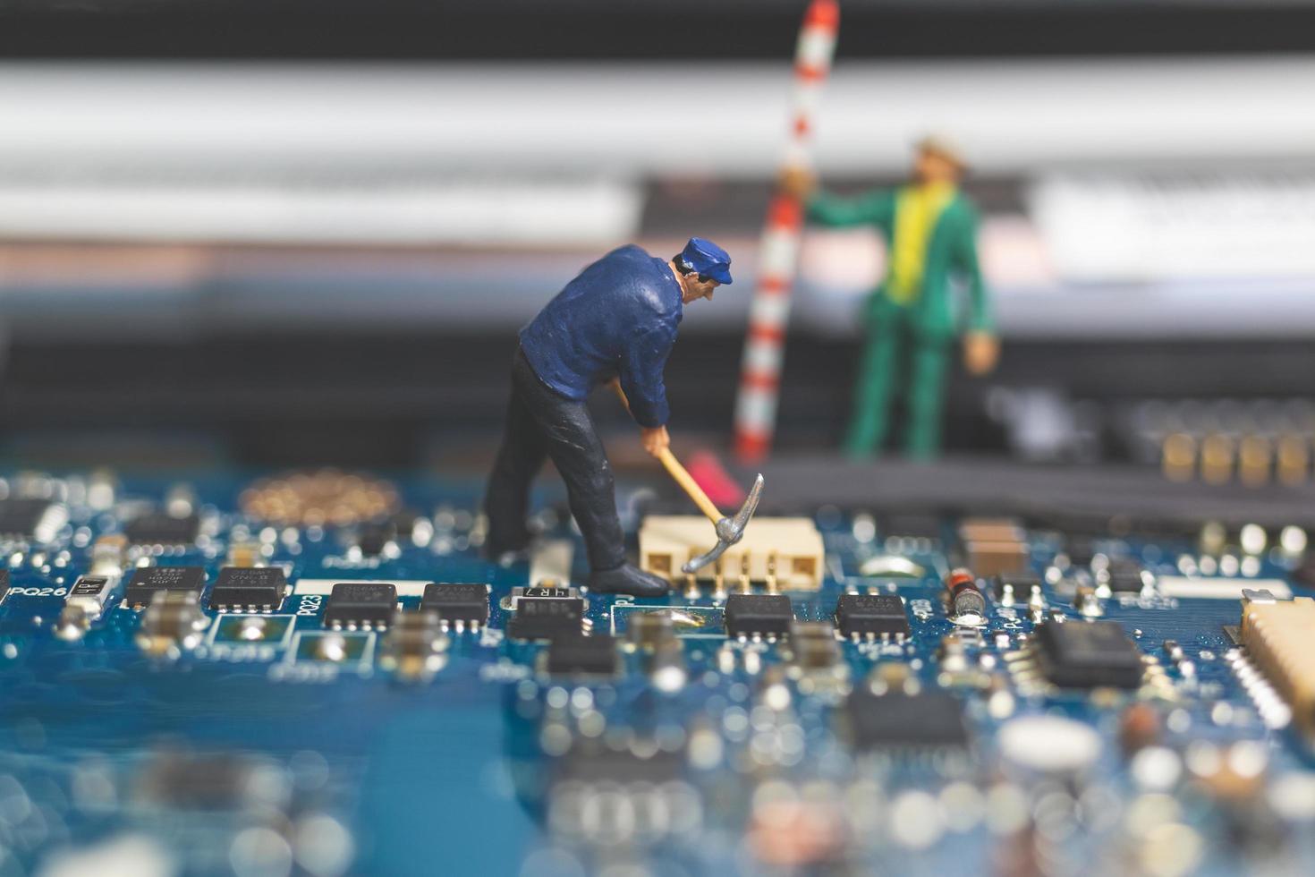 equipe em miniatura de engenheiros consertando um laptop de computador com teclado, conceito de conserto de computador foto