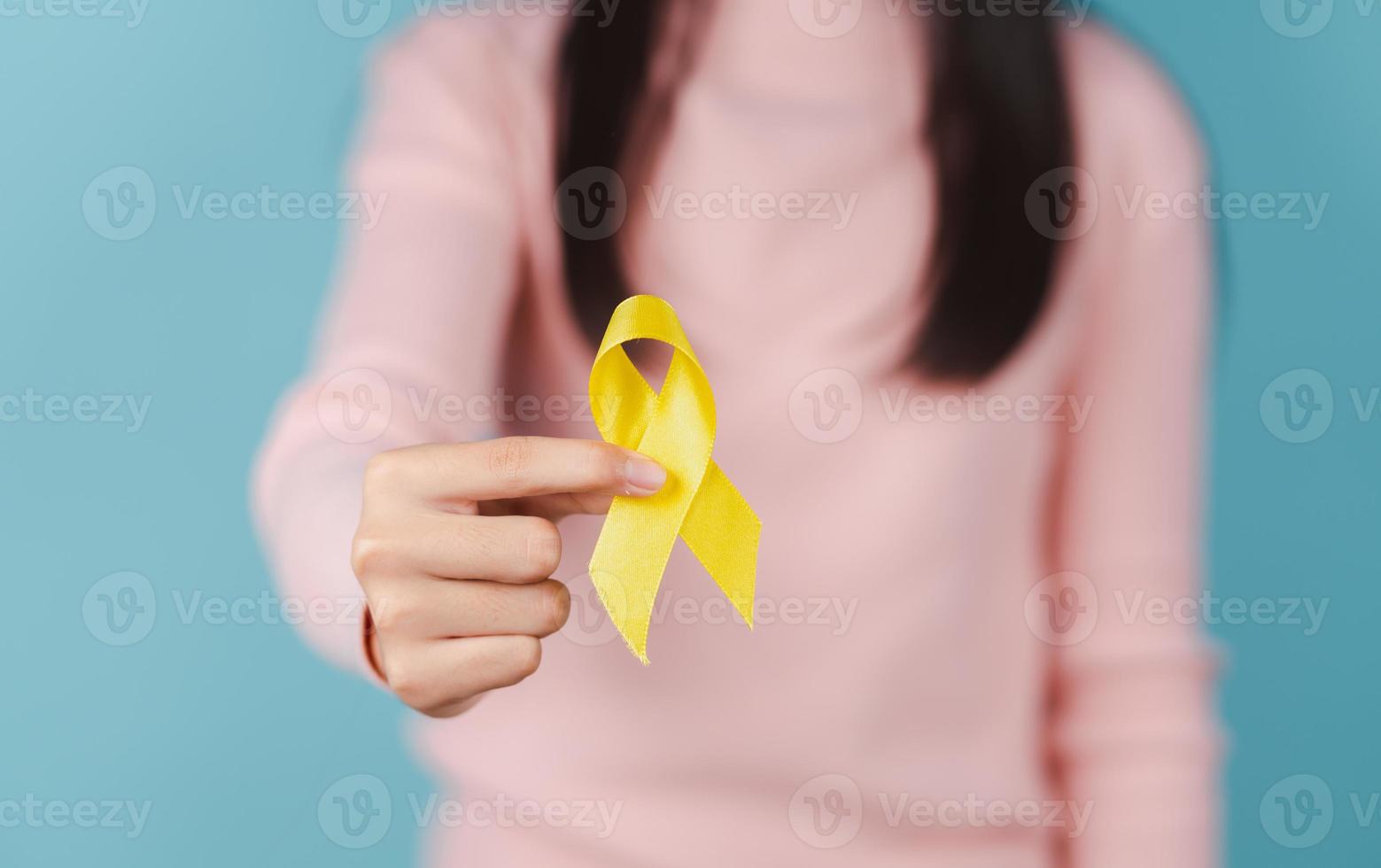 feliz mulher segurando amarelo fita, setembro, suicídio prevenção dia, infância, sarcoma, osso e bexiga Câncer consciência mês, saúde Cuidado Apoio, suporte pessoas e mundo Câncer dia conceito foto