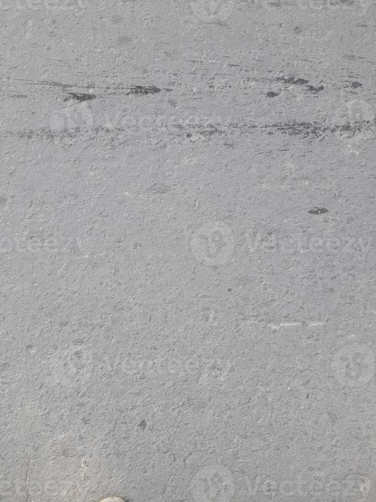 asfalto rude grunge superfície, desatado asfalto Sombrio cinzento rude estrada, fundo textura, topo Visão foto