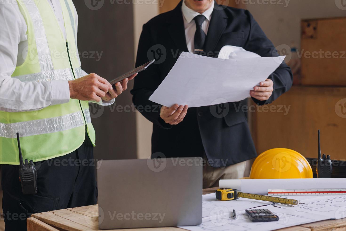 diverso equipe do especialistas usar tábua computador em construção local. real Estado construção projeto com Civil engenheiro, arquiteto, o negócio investidor e geral trabalhador discutindo plano detalhes. foto