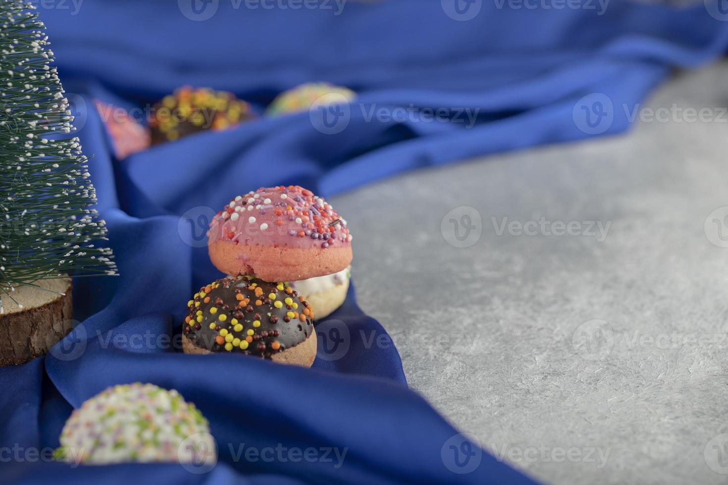 um brinquedo de árvore de natal com rosquinhas coloridas foto