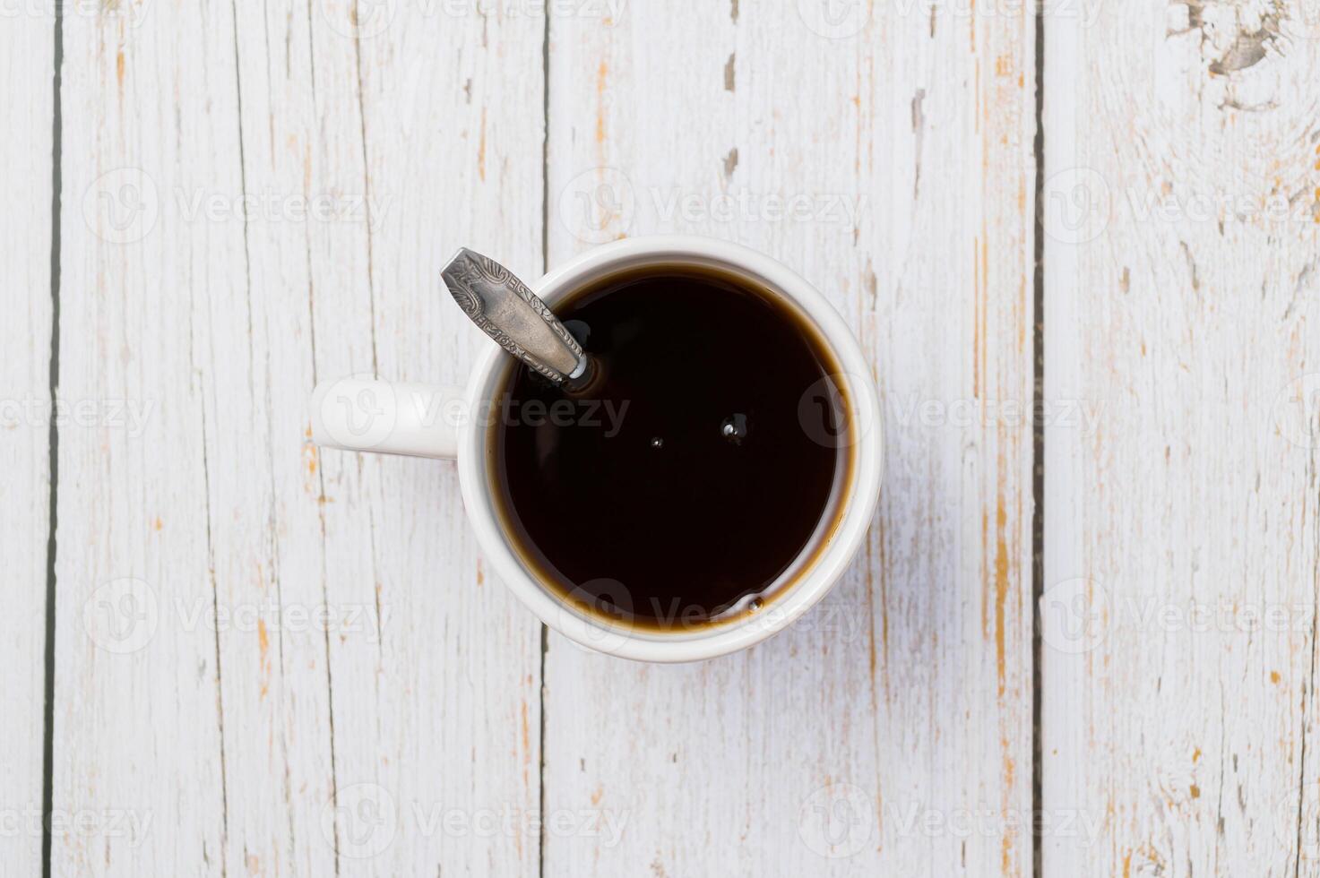 uma xícara de café em uma mesa de madeira foto