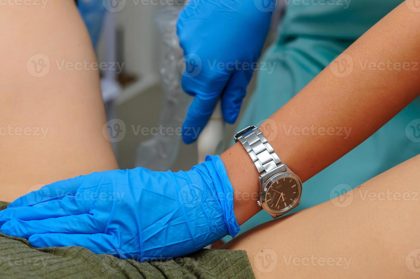 profissional ginecologista examinando dela fêmea paciente em uma ginecológico cadeira foto