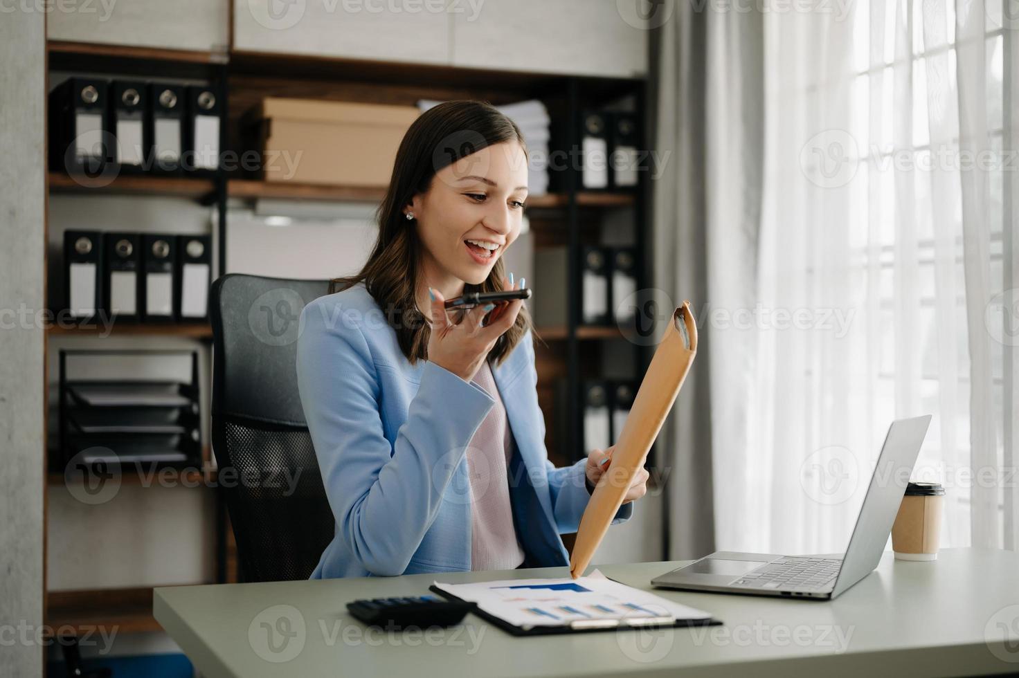 lindo o negócio mulher digitando computador portátil e tábua colocada às a mesa às a moderno escritório foto