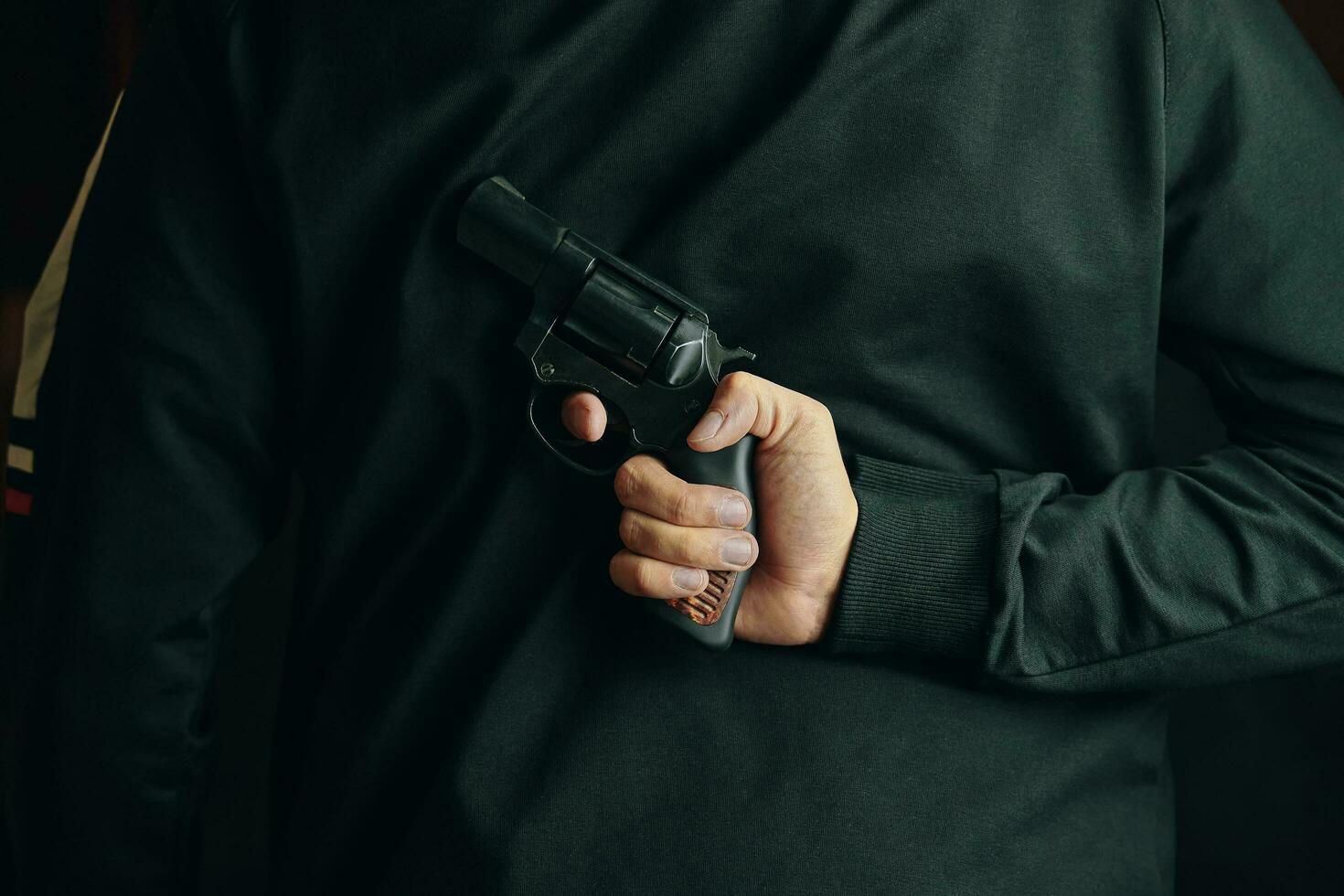 um homem com um revólver nas costas foto