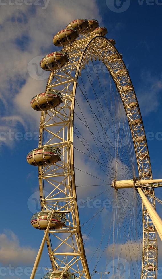 ferris roda dentro a diversão parque em fundo do azul céu com nuvens. baixo ângulo Visão do uma grande ferris roda. foto