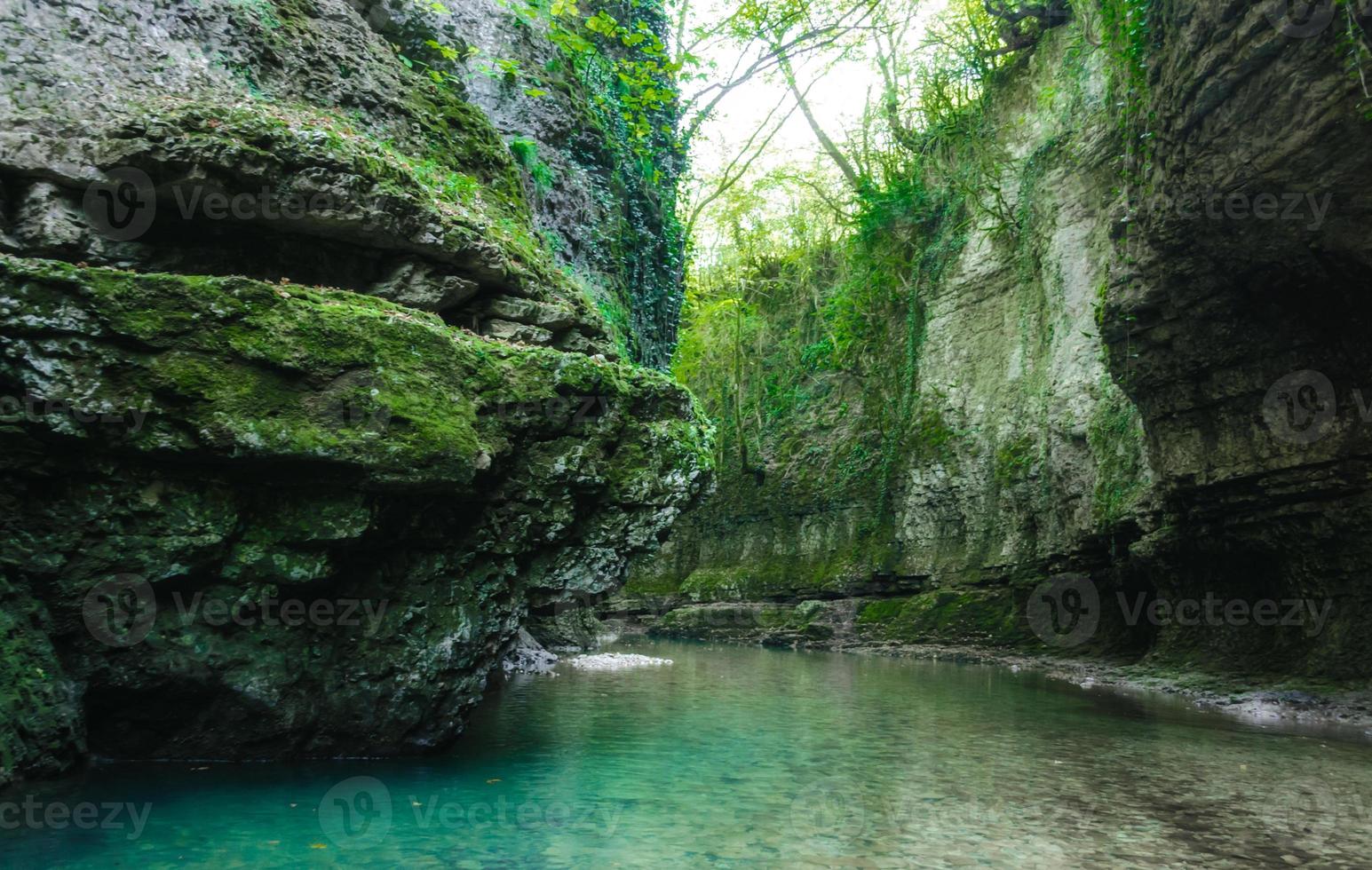 água do rio azul e musgo verde nas rochas foto