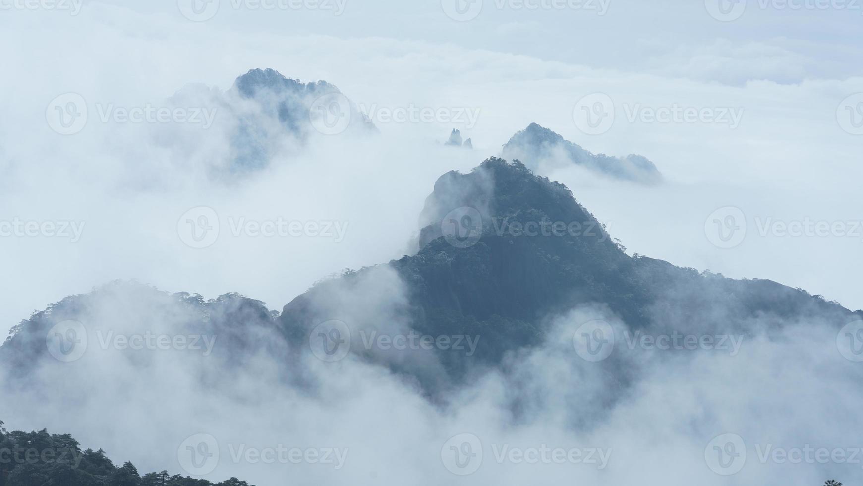 as belas paisagens das montanhas com a floresta verde e o penhasco rochoso em erupção como pano de fundo na zona rural da china foto