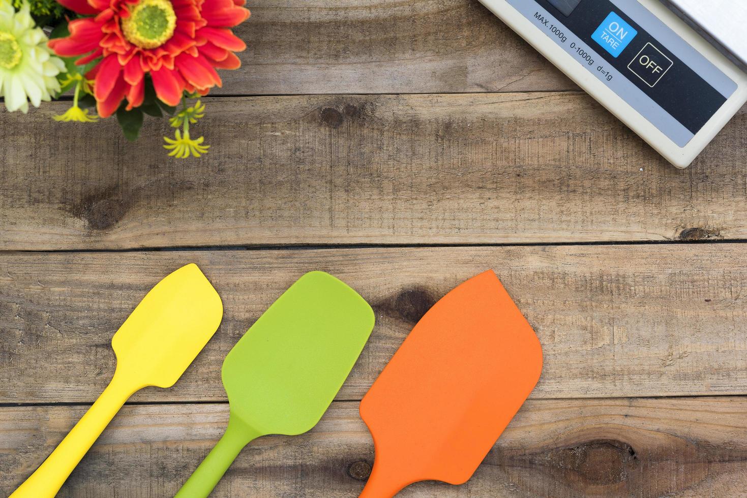 Padaria de silicone e utensílios de cozinha em uma mesa de madeira foto