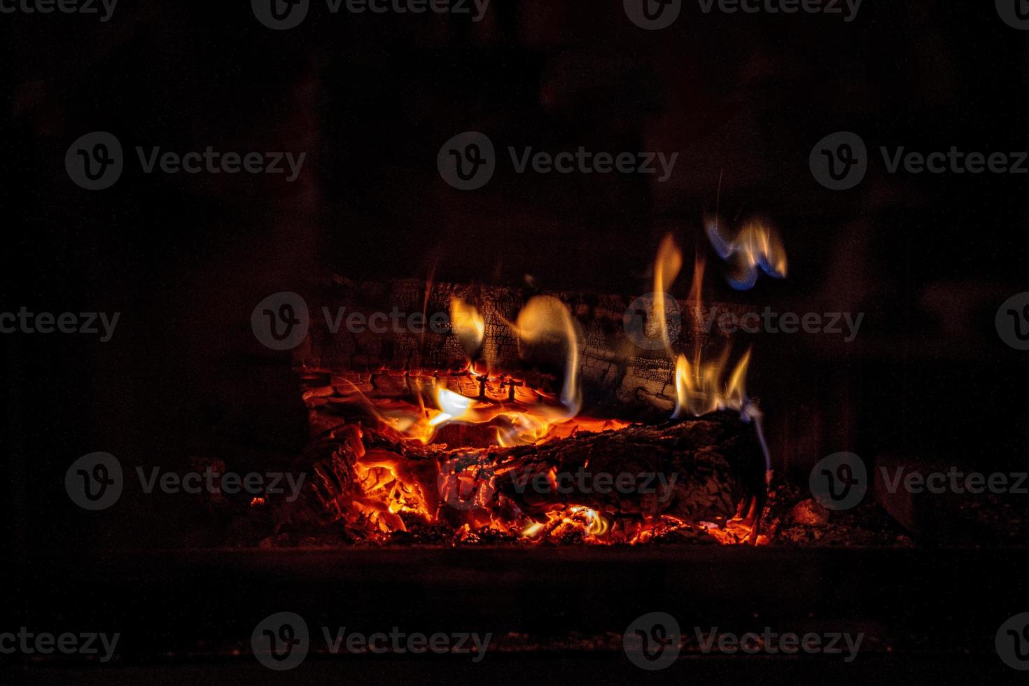 quente fogo queimando dentro uma doméstico lareira em uma inverno dia foto