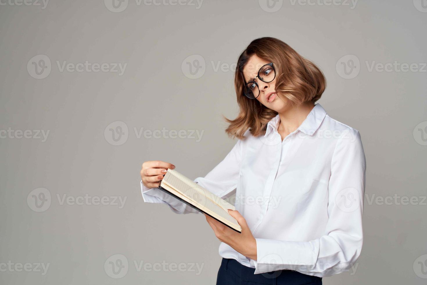 o negócio mulher dentro branco camisa documentos trabalhos oficial foto