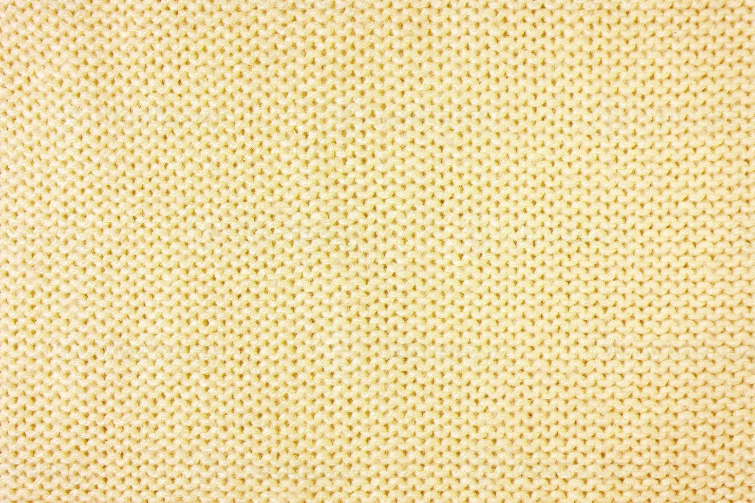 fundo de textura de tecido de lã de malhas amarelo brilhante. pano de fundo têxtil abstrato foto