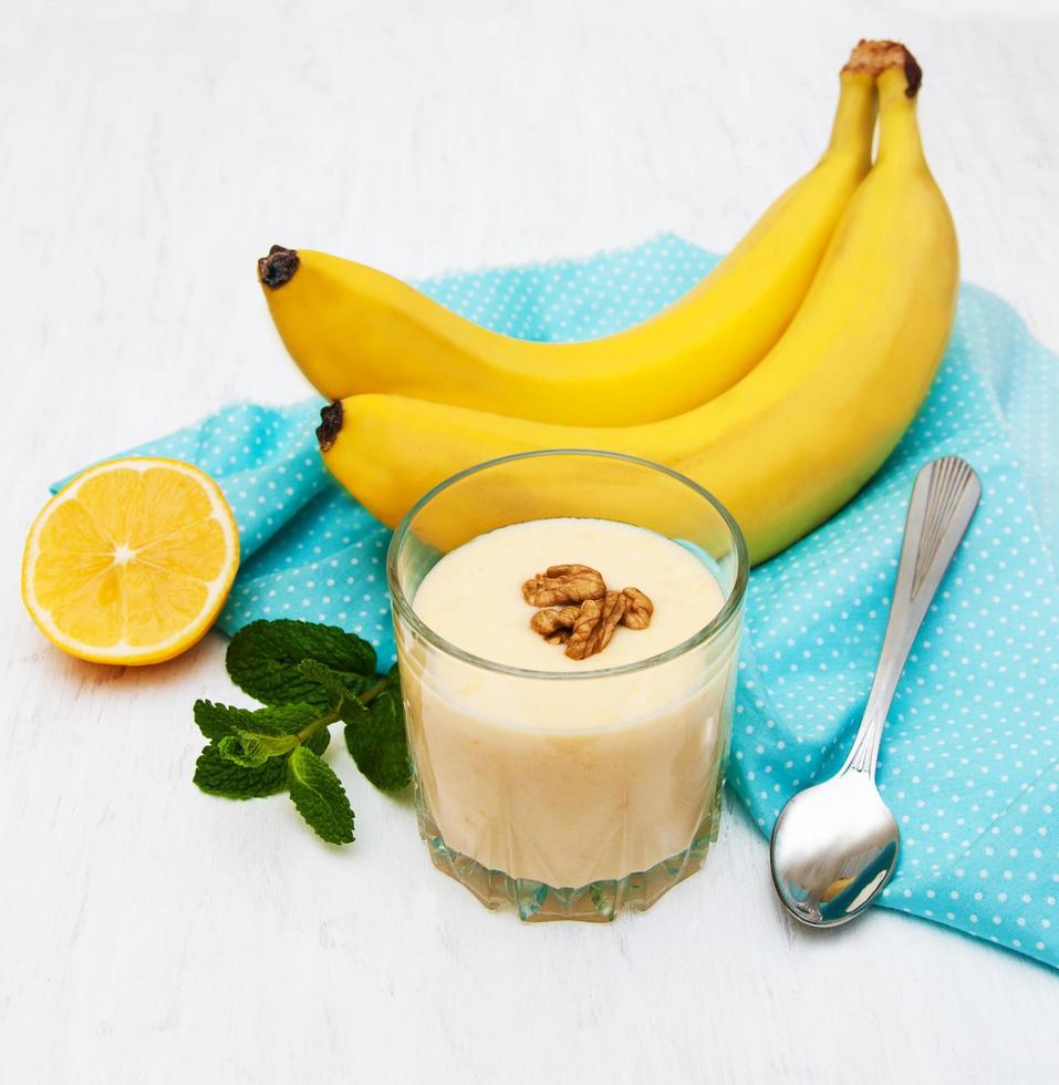 smoothie de banana com chocolate em um velho fundo branco de madeira foto