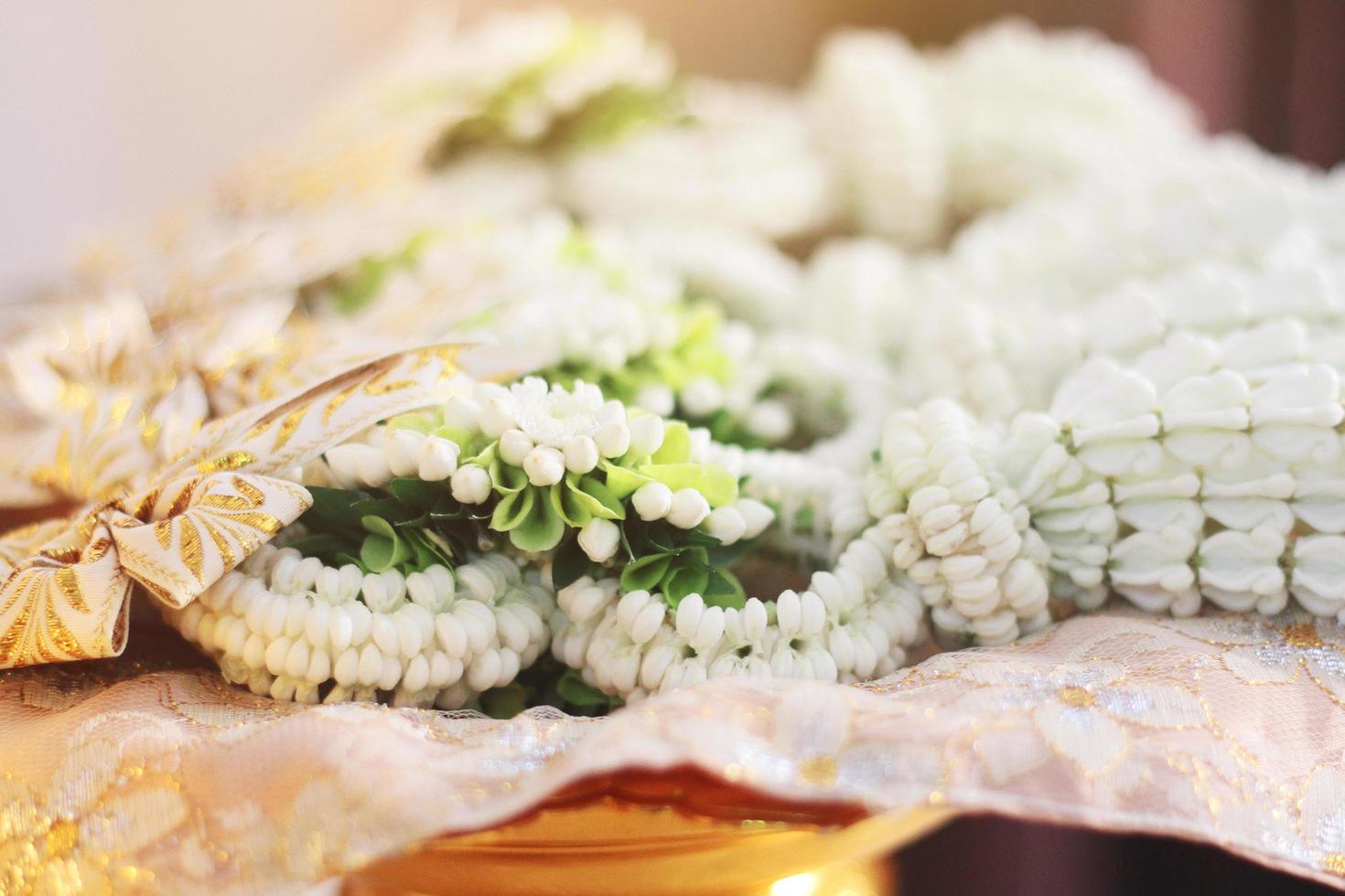 flor guirlandas em uma ouro bandeja dentro tradição tailandês Casamento cerimônia dia. jasmim festão. foto