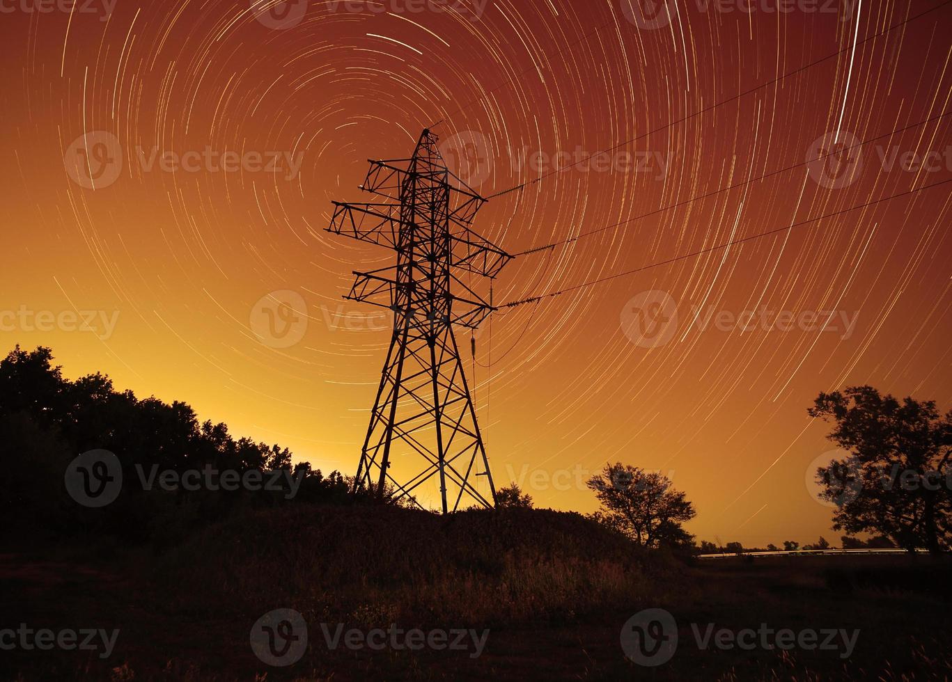 espaço energia, transmissão torre contra Estrela trilhas dentro noite céu foto