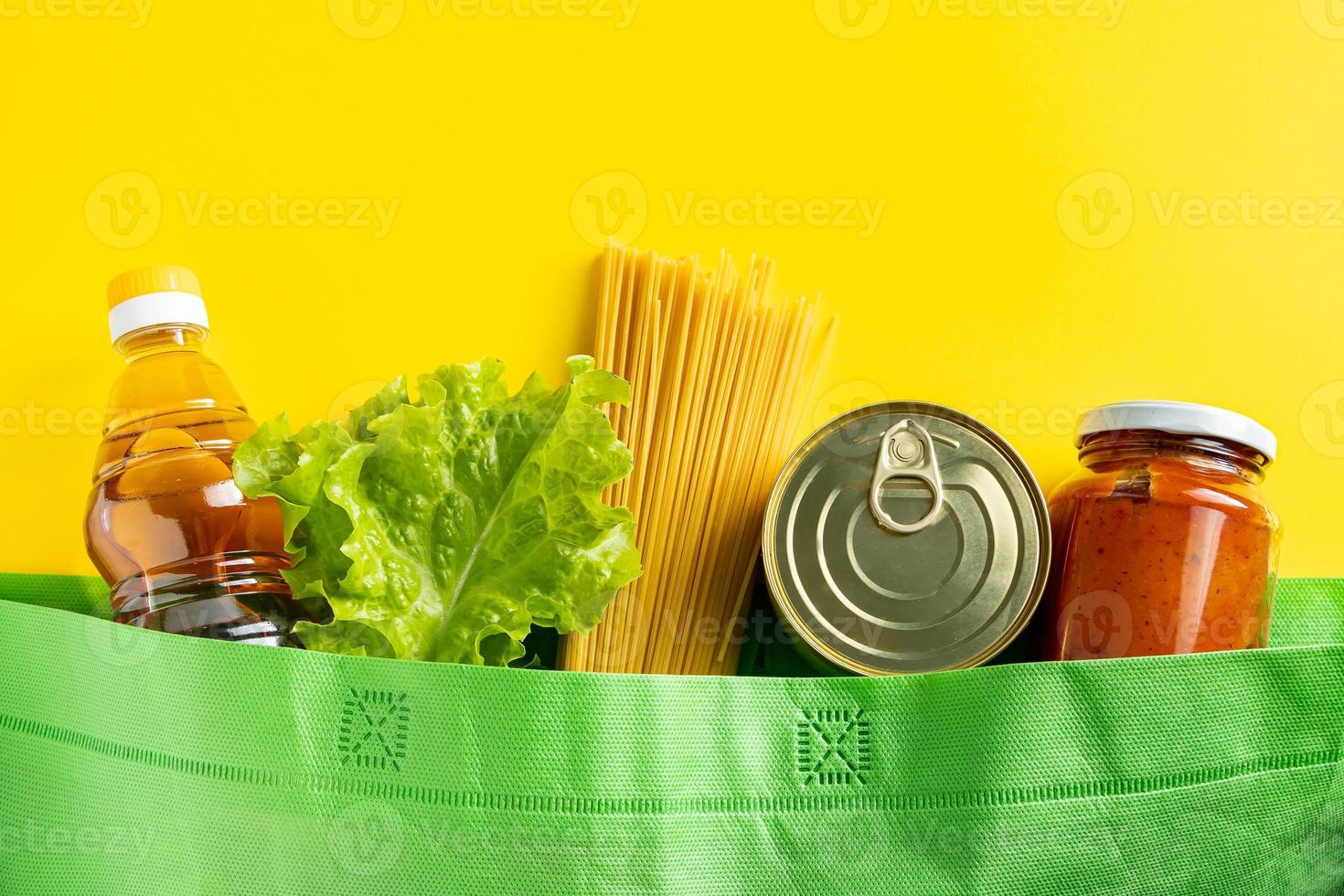 conceito de entrega de comida em um fundo amarelo. saco biodegradável com alimentos essenciais. foto