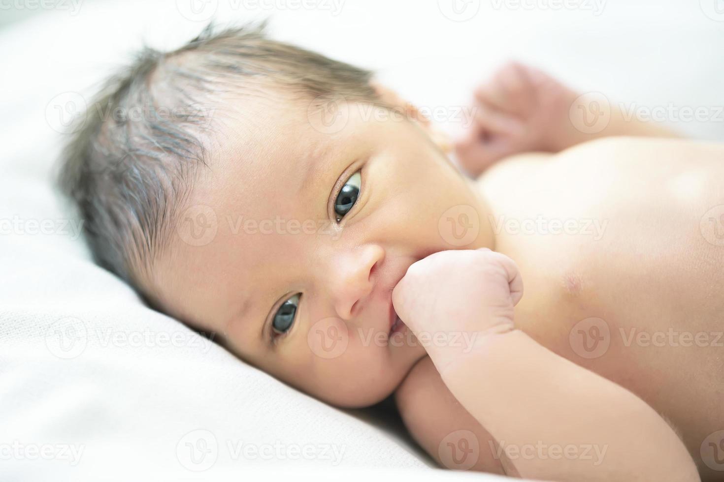recém-nascido bebê com aberto olhos é uma merda em uma cam. foto