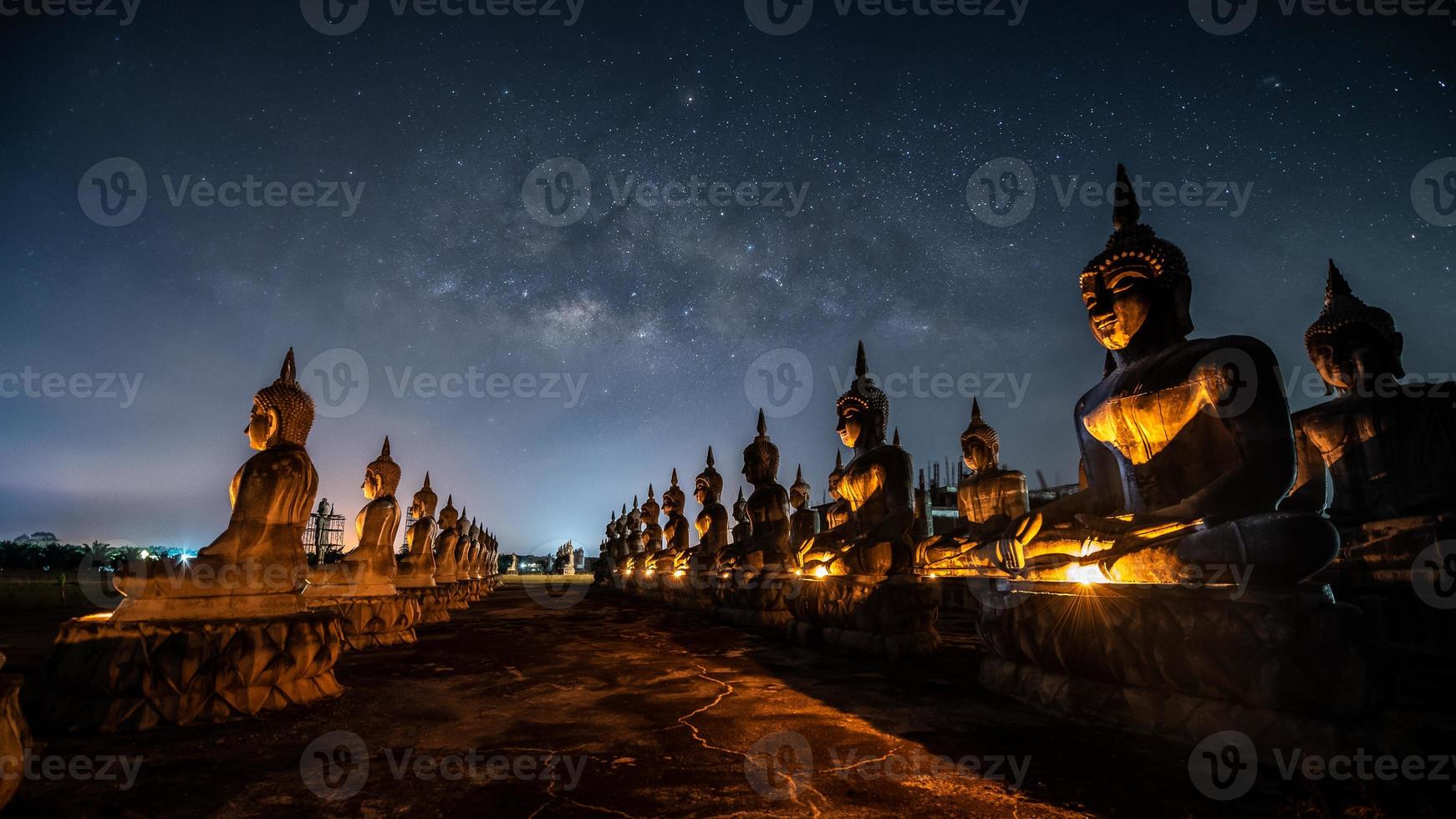 Galáxia da Via Láctea sobre muitas estátuas de Buda em Nakhon Si Thammarat, Tailândia foto