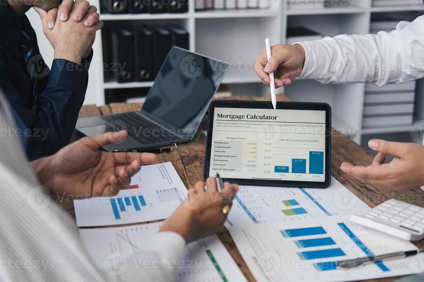 fechar acima Visão do o negócio parceiros discutindo documentos e Ideias às encontro quarto enquanto usando digital tábua para presente seus ideia. foto