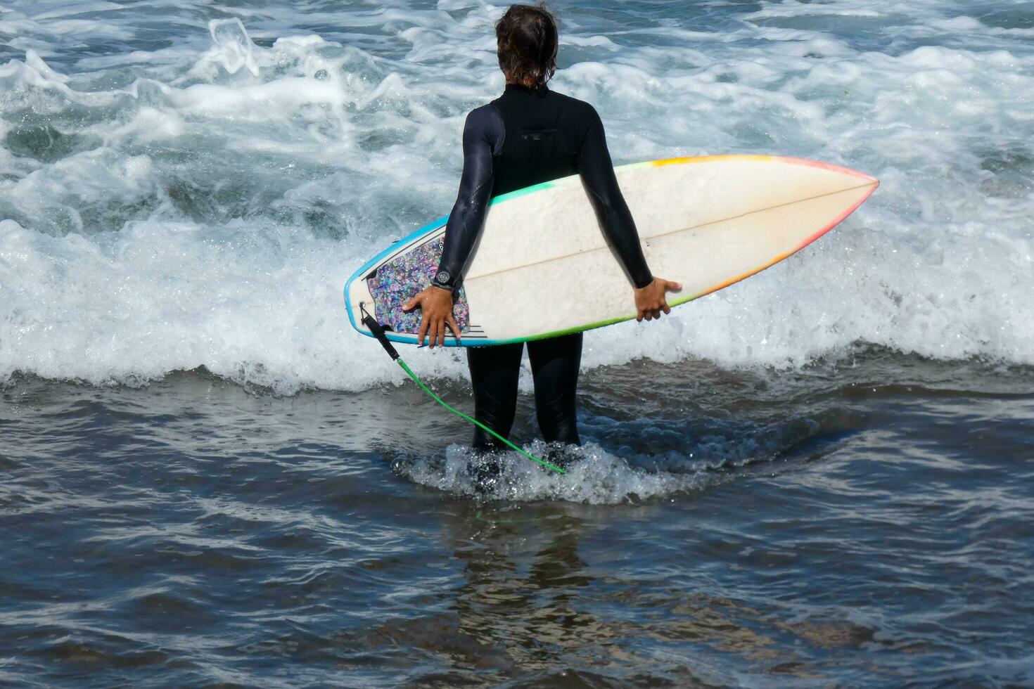 surfistas obtendo pronto para entrar a água e caminhando com a borda ao longo a costa. foto