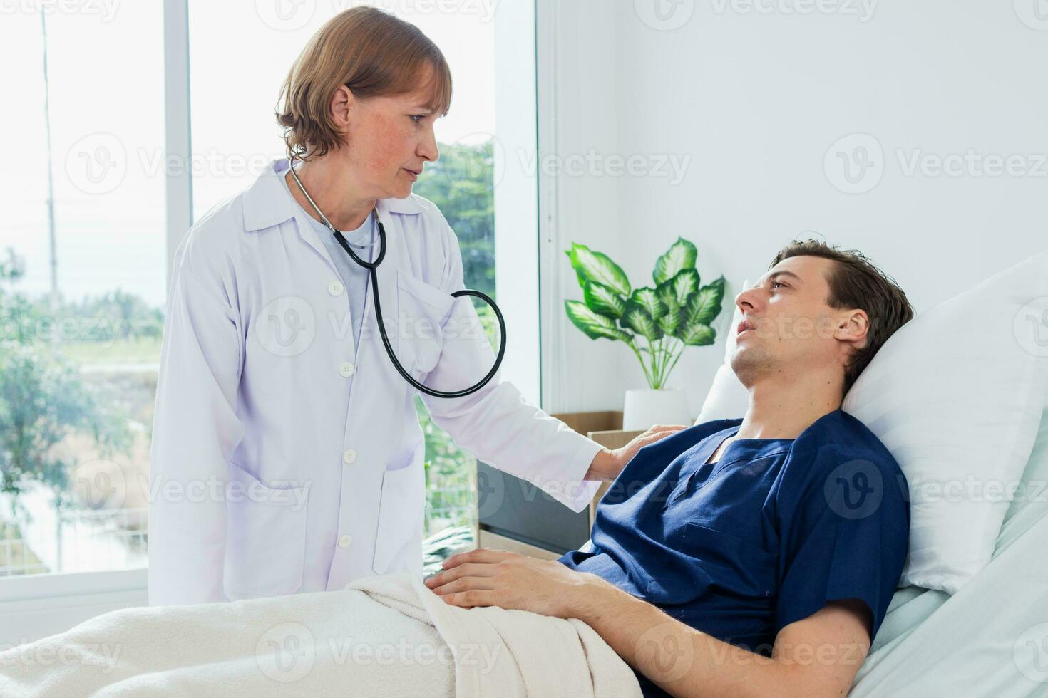 a médico é examinando a paciente dentro a hospital. caucasiano fêmea médico falando para masculino paciente deitado dentro hospital cama. foto