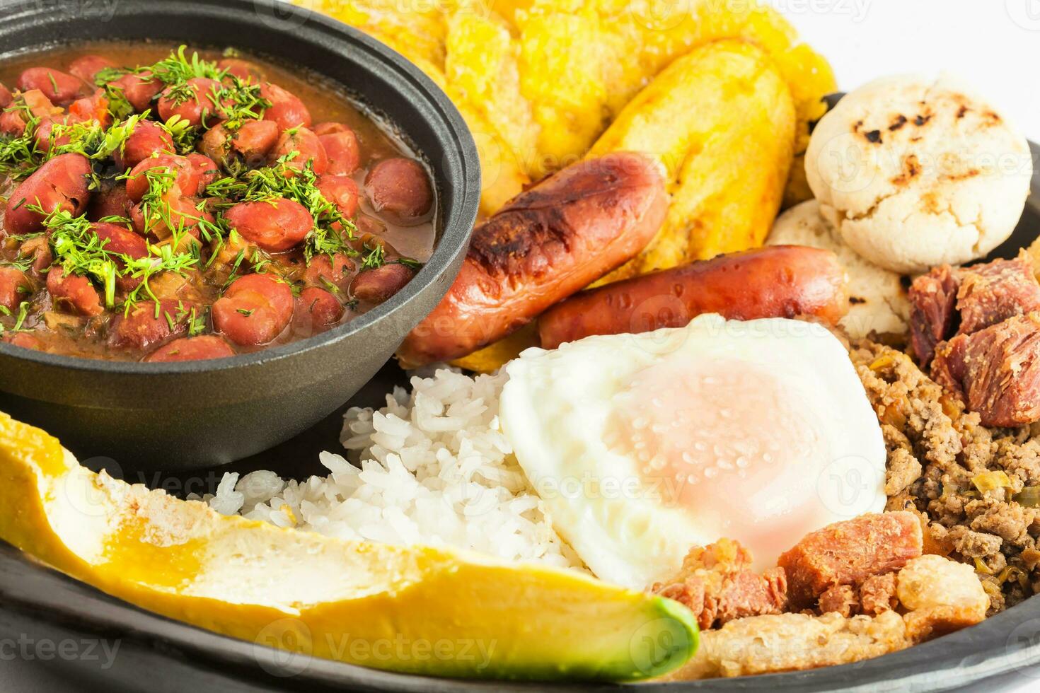 tradicional colombiano prato chamado banda paisa uma prato típica do Medellin este inclui carne, feijões, ovo e bananeira foto