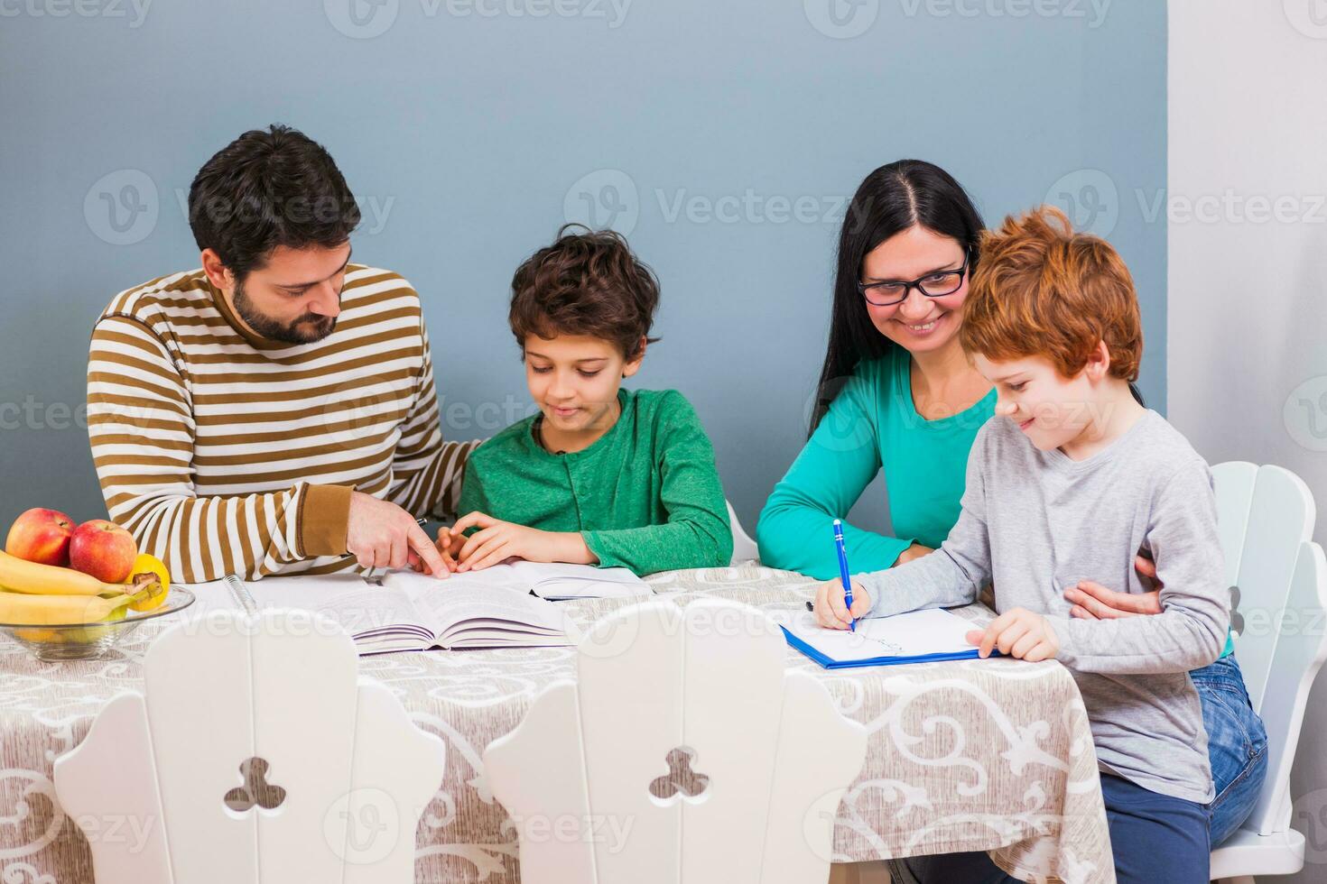 pais ajudando seus crianças com seus dever de casa foto