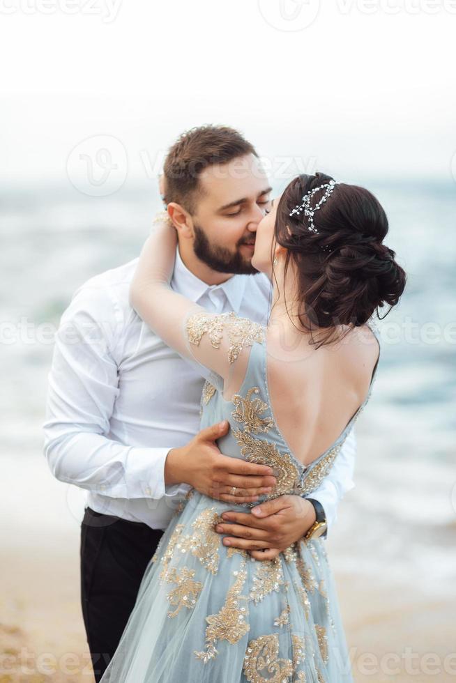 o mesmo casal com uma noiva em um vestido azul anda foto