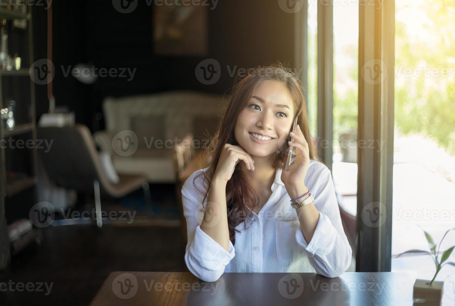 mulher asiática falando ao telefone foto