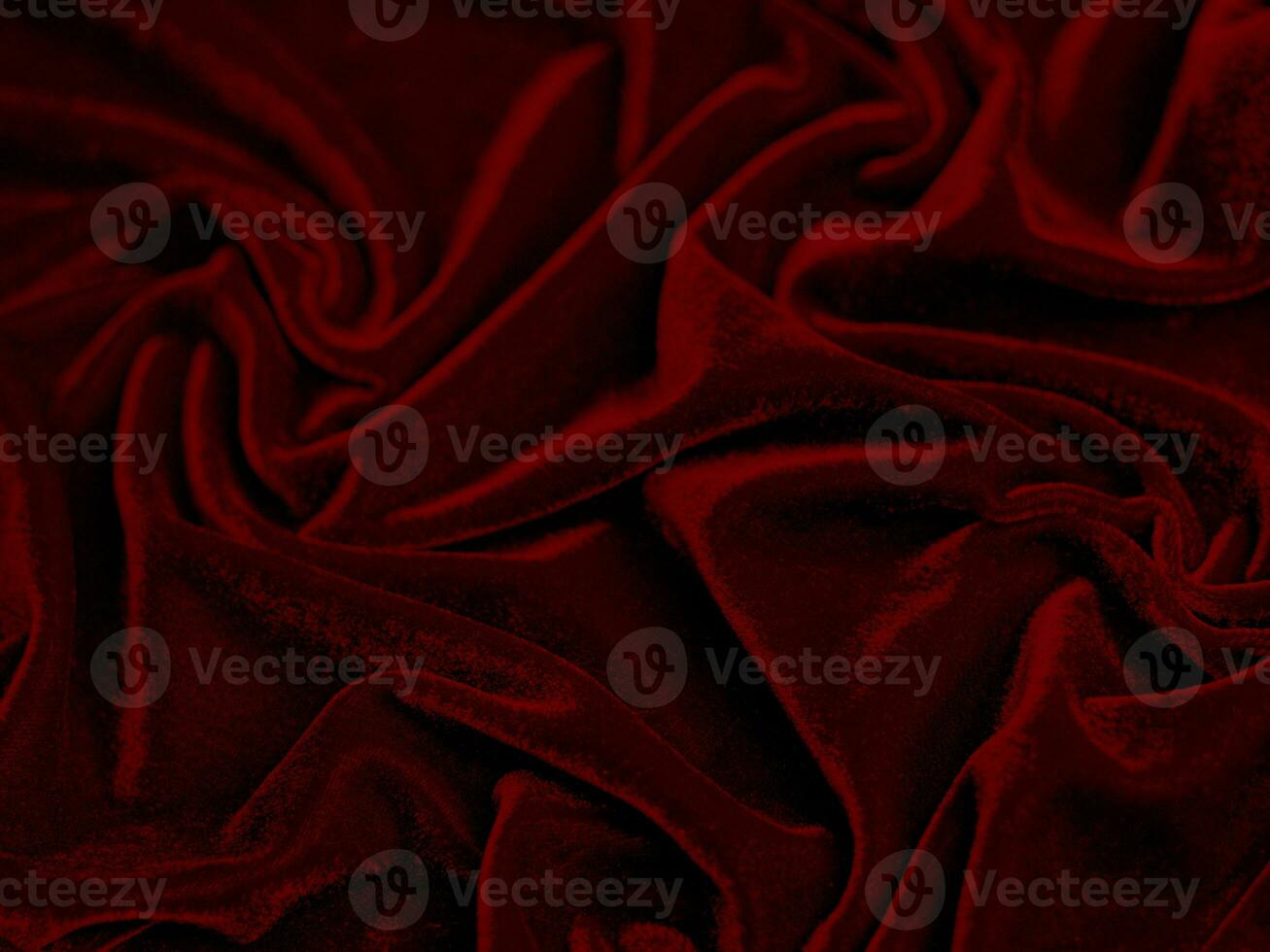 textura de tecido de veludo vermelho usada como plano de fundo. fundo de tecido vermelho vazio de material têxtil macio e liso. há espaço para o texto.. foto