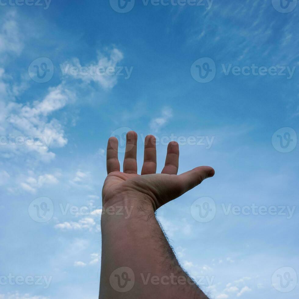 mão para cima gesticulando no céu azul, sentimentos e emoções foto