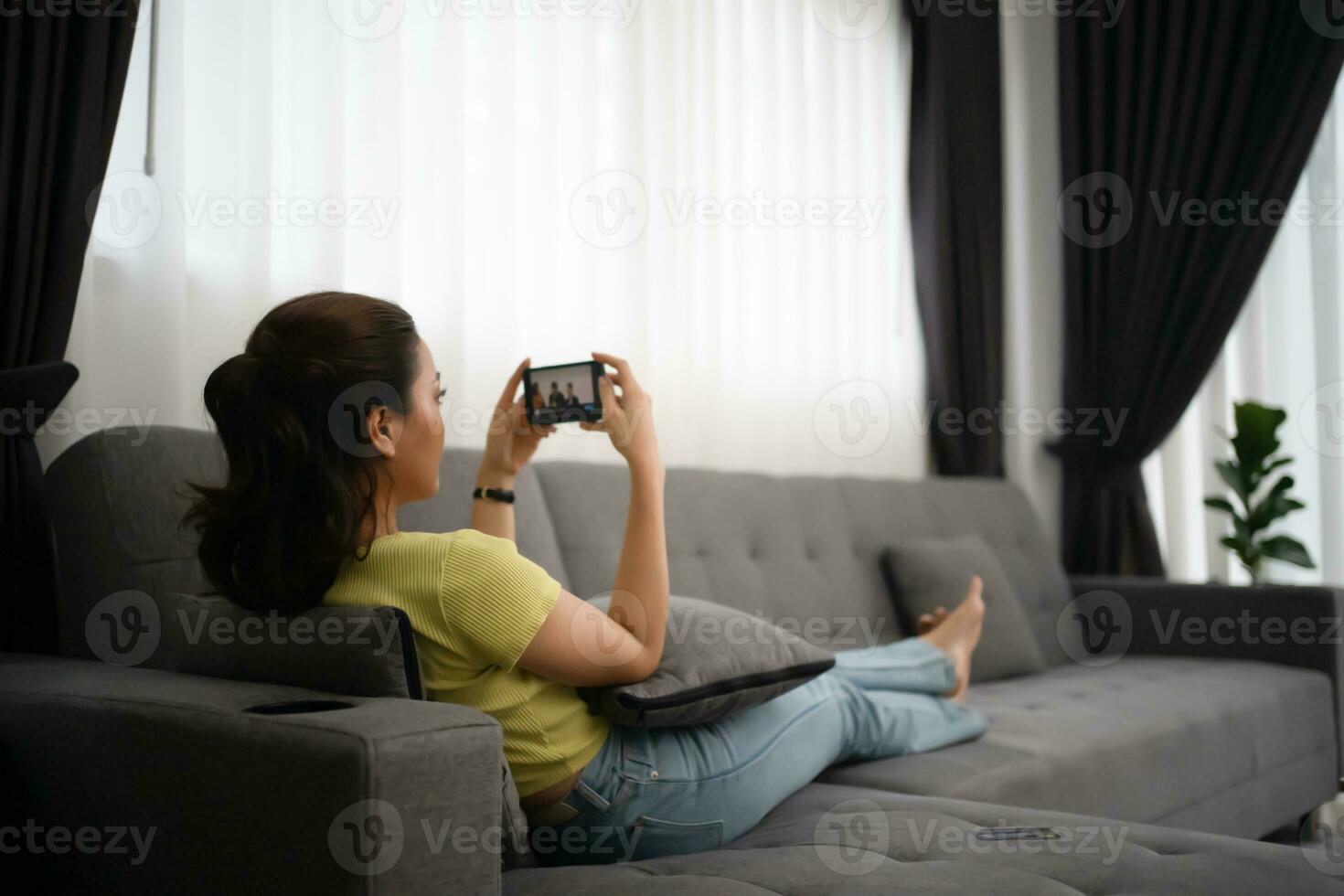 mulher usando inteligente telefone e navegando Internet às casa foto