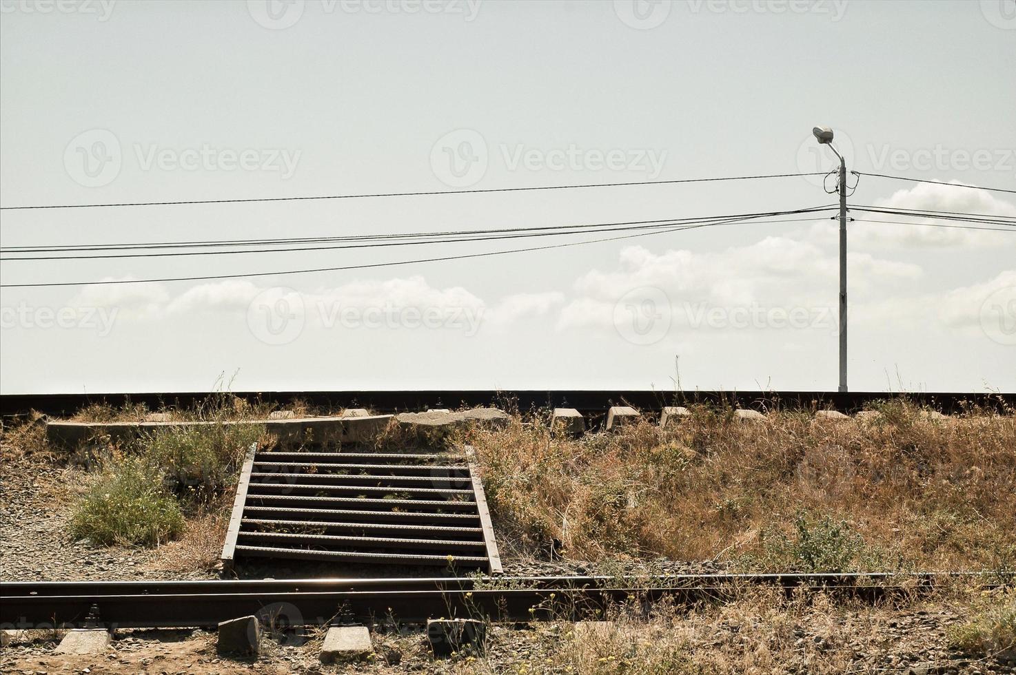 uma escada de ferro através da ferrovia foto