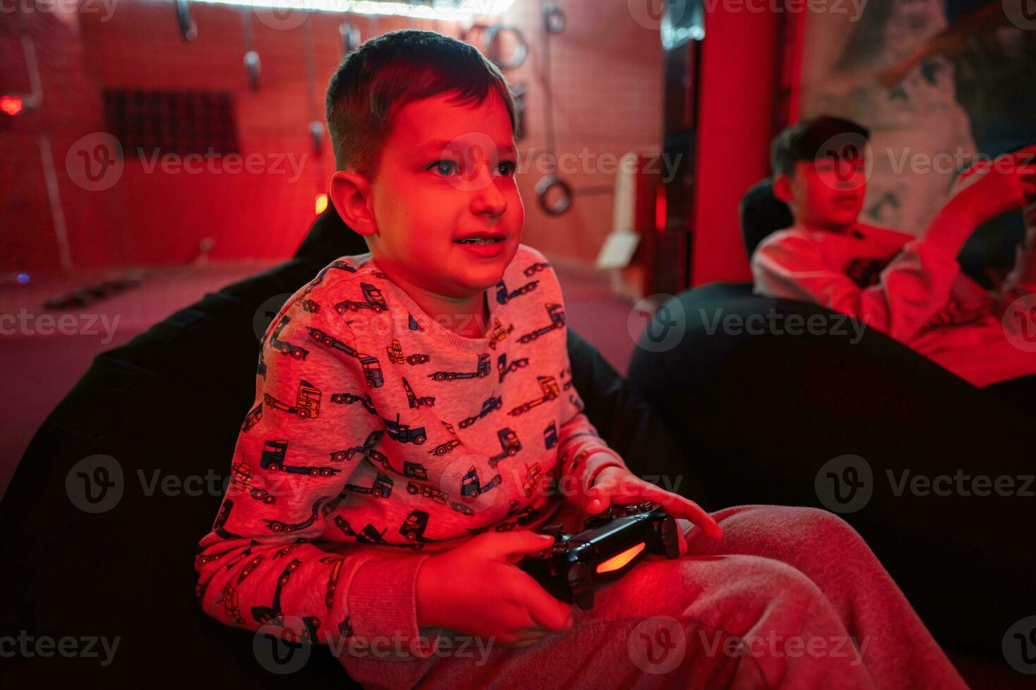 dois Rapazes gamers jogar controle vídeo jogos console dentro vermelho jogos sala. foto