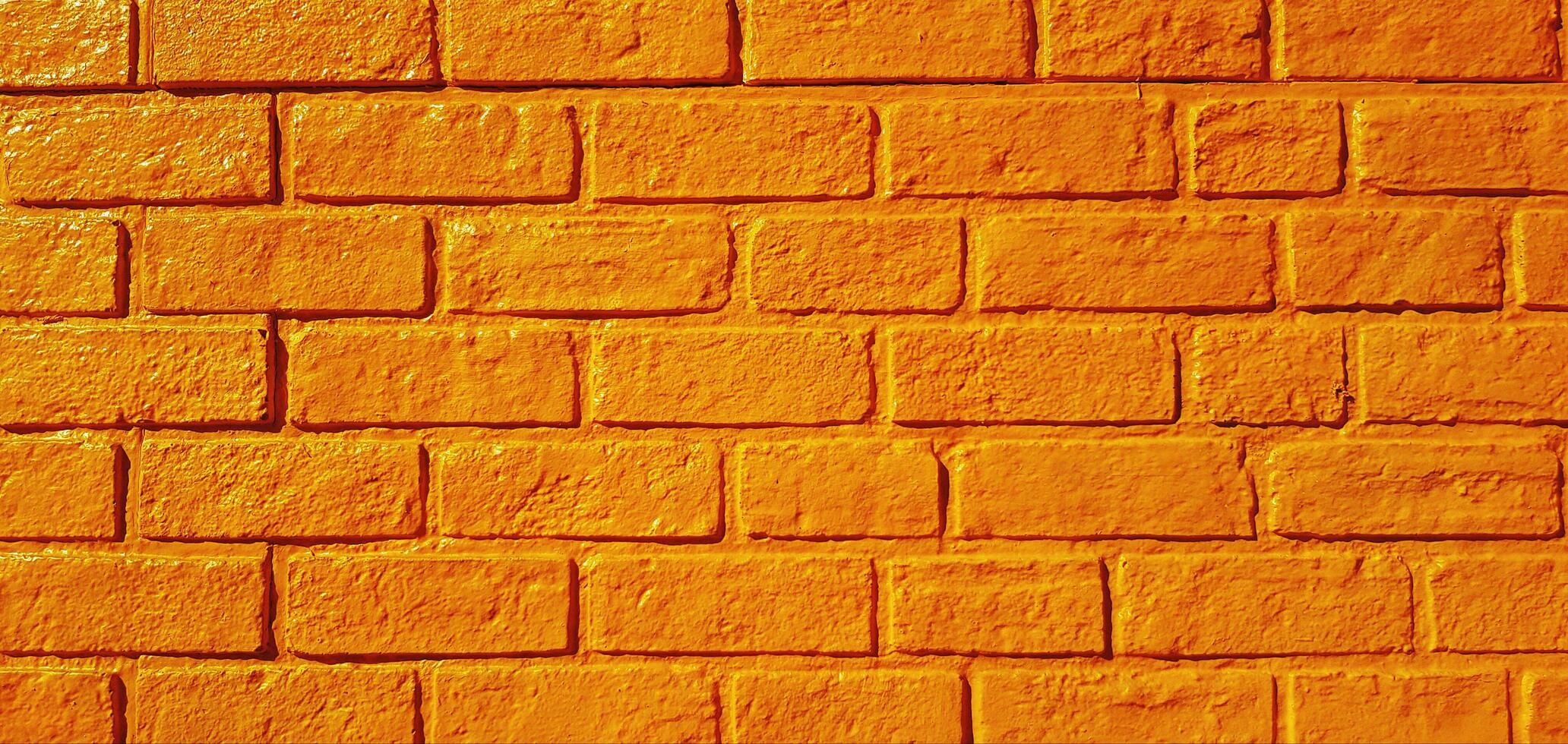 padronizar amarelo tijolo parede pintado para fundo. arte papel de parede e arquitetura exterior Projeto conceito foto