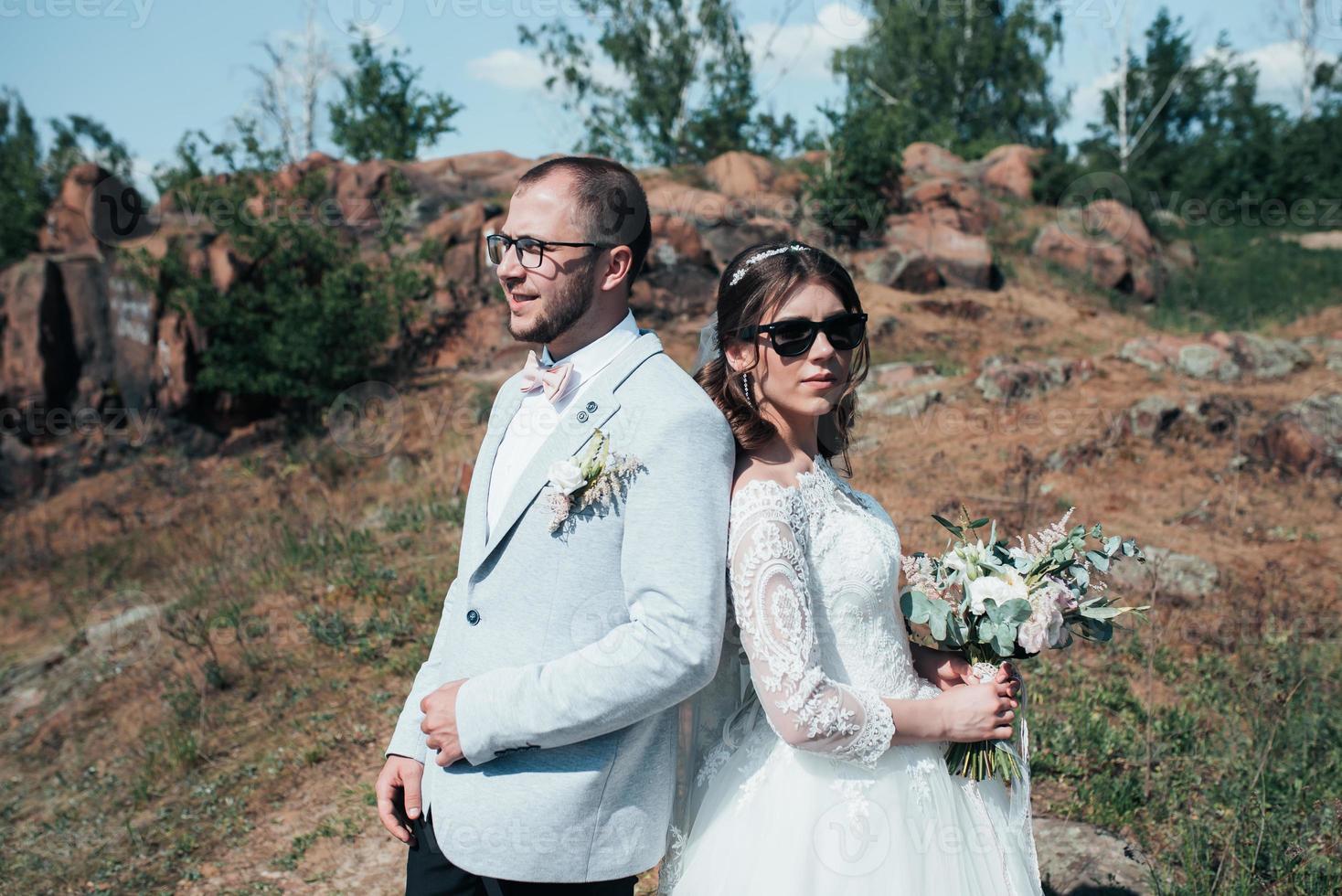 fotografia de casamento moda noiva e noivo em óculos de sol na natureza com gelo foto