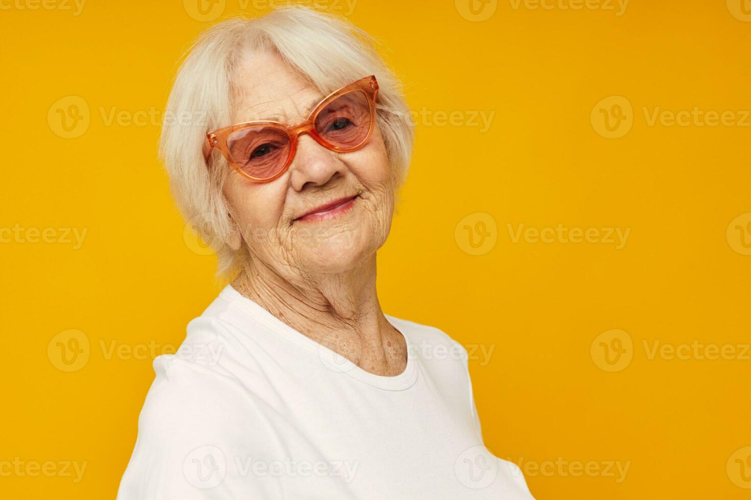 retrato do a velho amigáveis mulher dentro casual camiseta e óculos fechar-se emoções foto